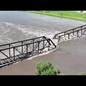 At least 2 killed, dam breached and bridge toppled in Midwest floods