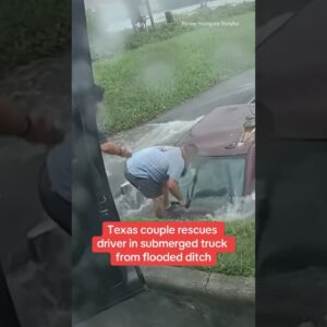 Texas couple rescues driver in submerged truck from flooded ditch #shorts