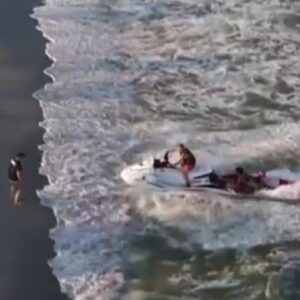 Watch: Crews on jet skis rescue swimmers in distress