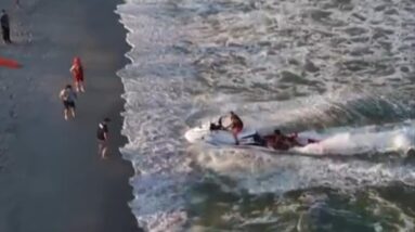 Watch: Crews on jet skis rescue swimmers in distress