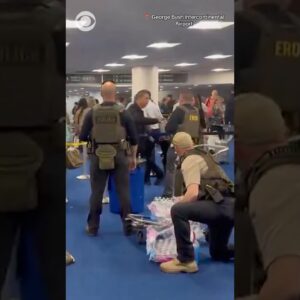 Unmasked ICE officers hand out bottled water to travelers in long TSA lines in Houston #shorts