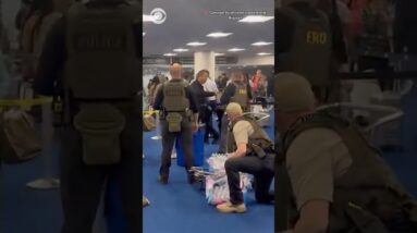 Unmasked ICE officers hand out bottled water to travelers in long TSA lines in Houston #shorts